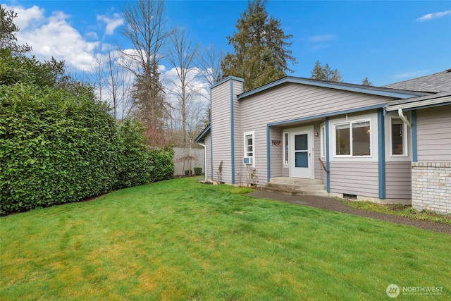 exterior space with a chimney and a front lawn