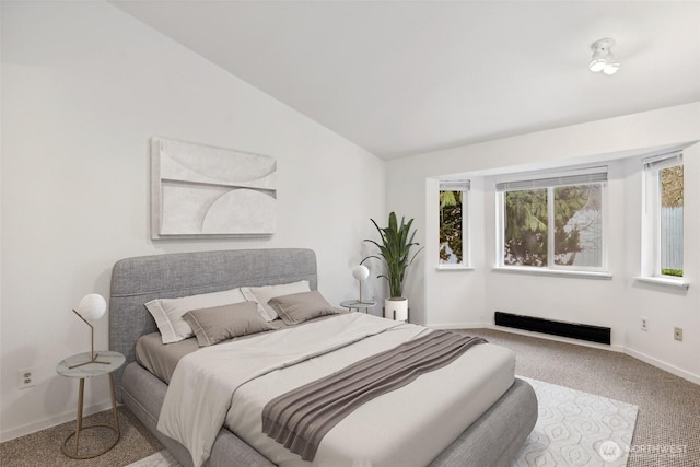 carpeted bedroom with baseboards and vaulted ceiling