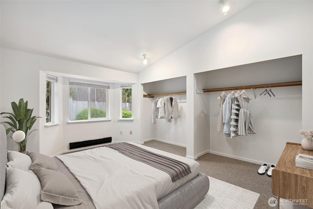 bedroom featuring lofted ceiling, carpet, and baseboards