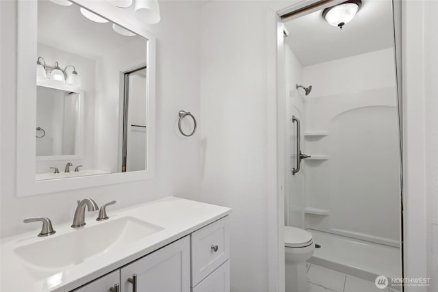 bathroom with a shower, marble finish floor, vanity, and toilet