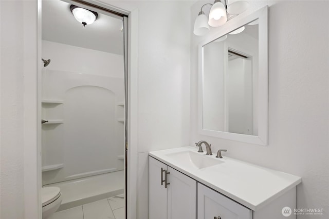 full bathroom with marble finish floor, vanity, toilet, and walk in shower