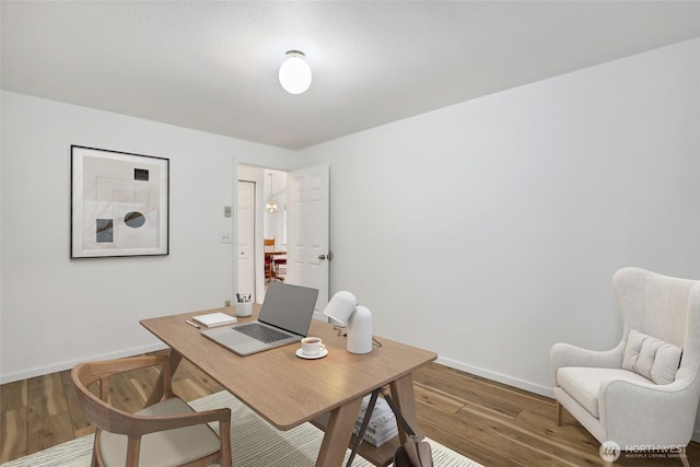 home office with wood finished floors and baseboards