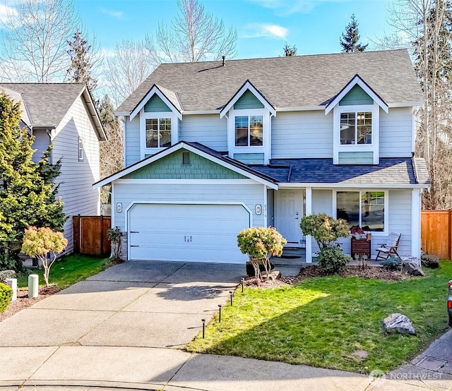 traditional-style home with a garage, a shingled roof, concrete driveway, fence, and a front yard