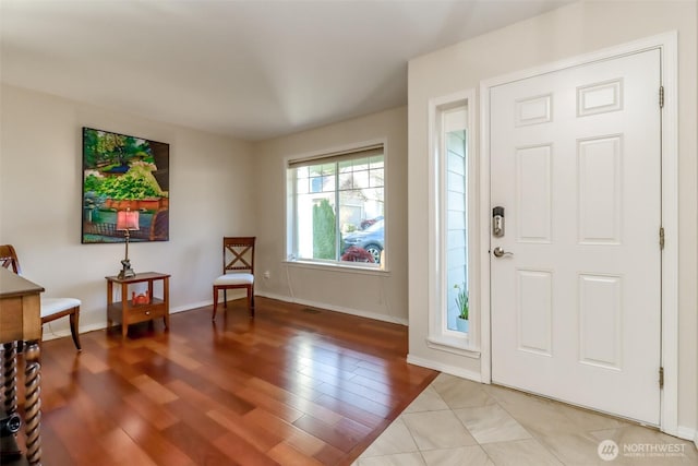 entryway featuring light wood-style floors and baseboards