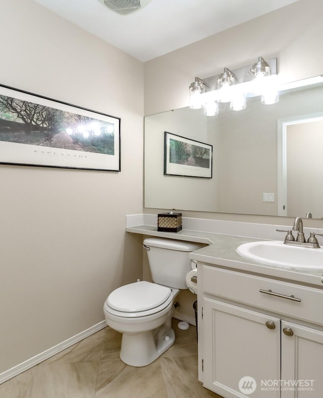 half bath featuring toilet, baseboards, visible vents, and vanity