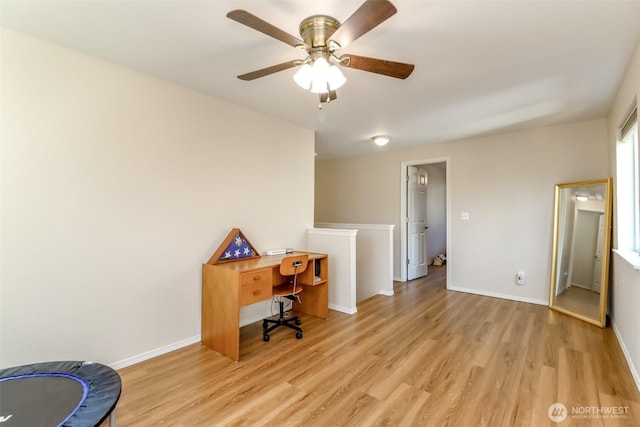 office space with a ceiling fan, light wood-style flooring, and baseboards