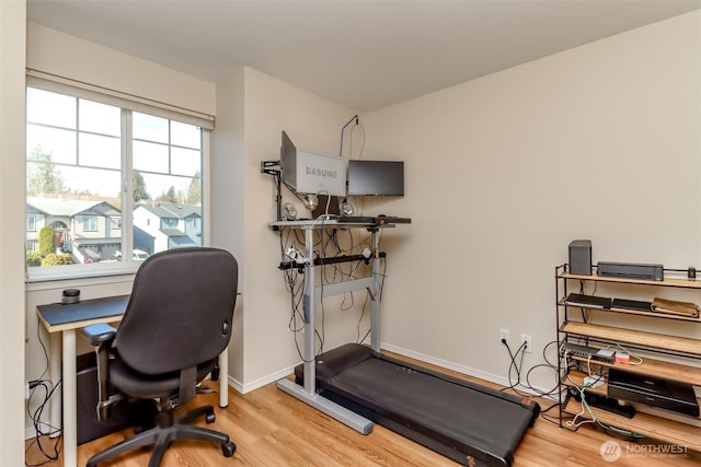 home office featuring wood finished floors and baseboards