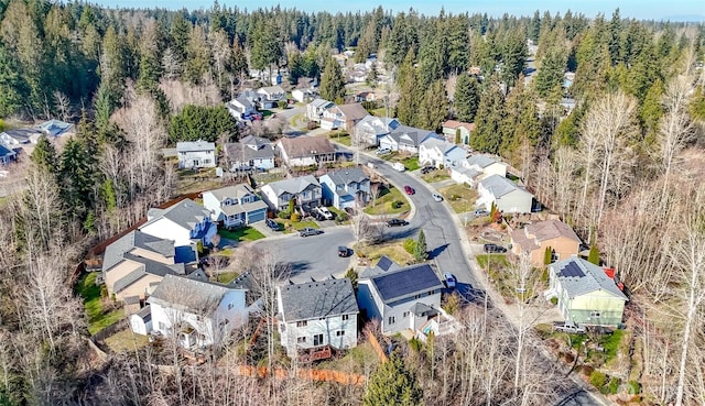 birds eye view of property featuring a forest view and a residential view