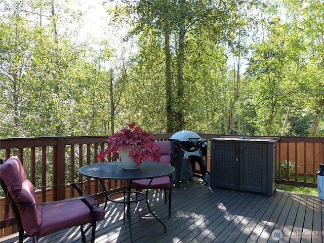 wooden terrace featuring outdoor dining area