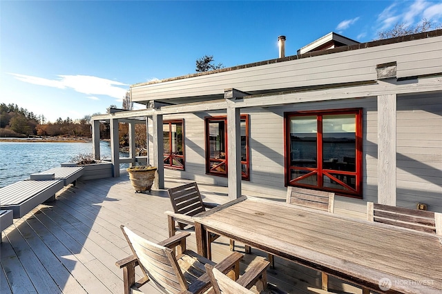 wooden terrace featuring a water view