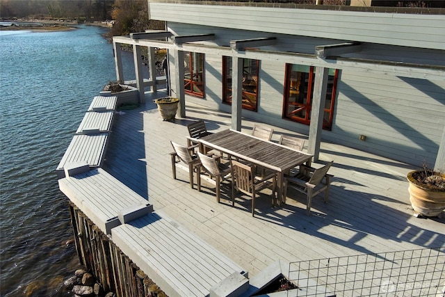 exterior space with outdoor dining space and a water view