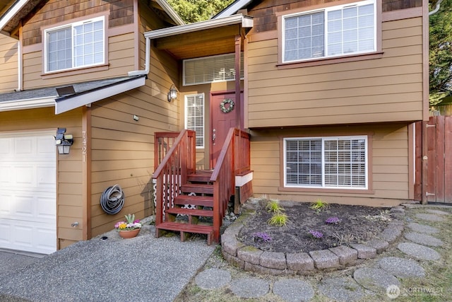 property entrance with a garage and fence