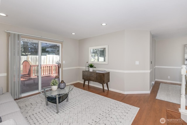 interior space with baseboards, wood finished floors, and recessed lighting