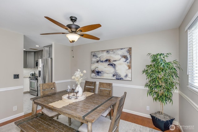 dining area featuring light wood finished floors, plenty of natural light, and baseboards