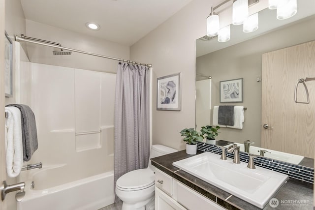 full bathroom featuring vanity, shower / bath combo with shower curtain, and toilet