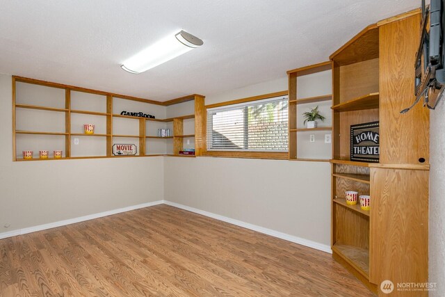 unfurnished room featuring wood finished floors and baseboards