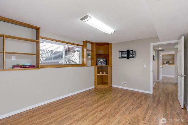 empty room featuring baseboards and wood finished floors