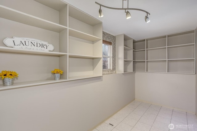 spacious closet with tile patterned floors