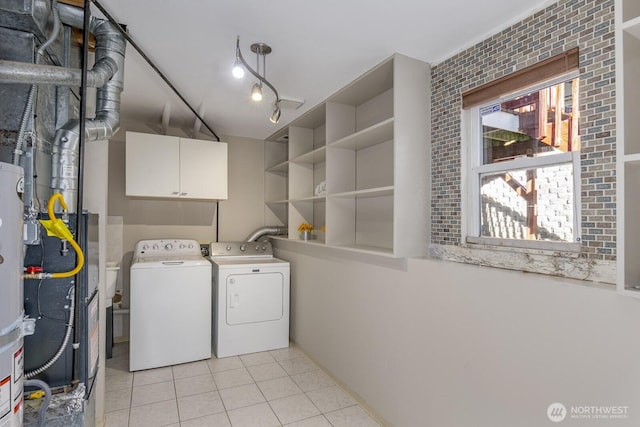 washroom with cabinet space, washer and clothes dryer, track lighting, and light tile patterned flooring