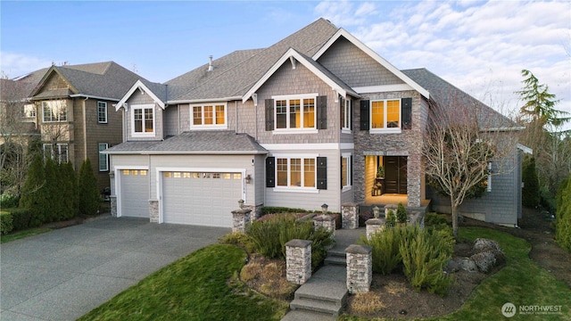 view of front of home featuring an attached garage, a shingled roof, and concrete driveway