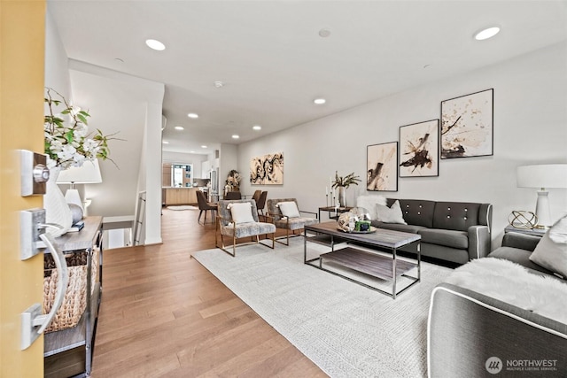 living room with recessed lighting and light wood finished floors