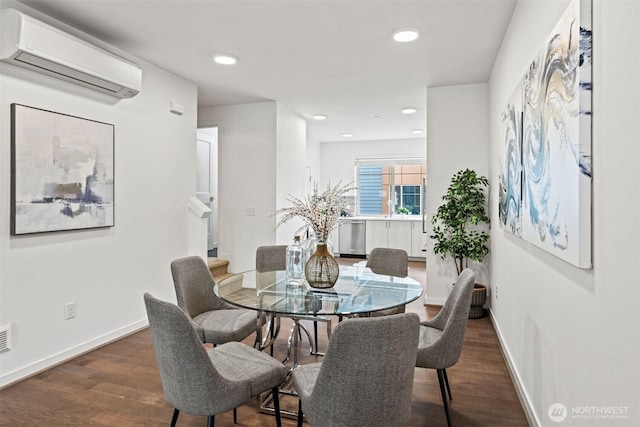 dining room featuring dark wood-style floors, recessed lighting, a wall mounted air conditioner, and baseboards