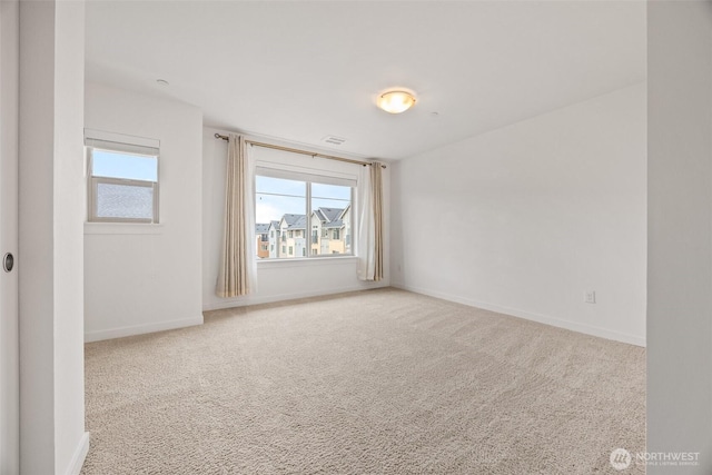 spare room featuring visible vents, baseboards, and carpet floors