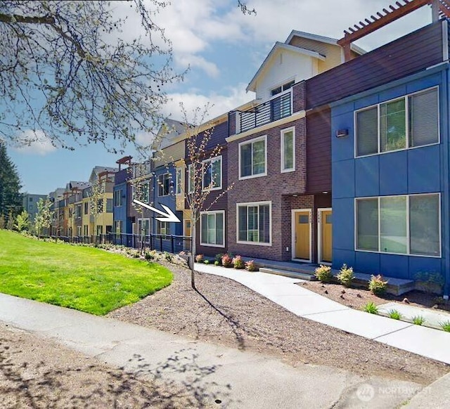 view of front facade with brick siding and a residential view