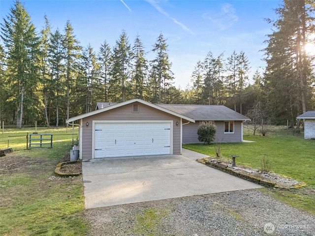 view of front of home featuring an attached garage, fence, concrete driveway, and a front yard