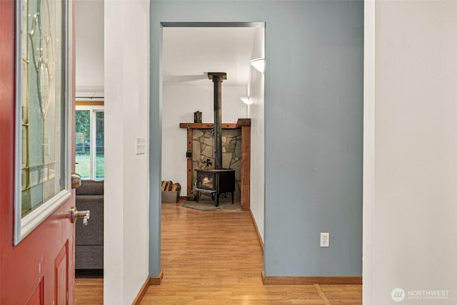 hall with light wood-type flooring and baseboards