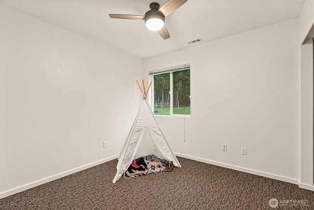 game room featuring ceiling fan, baseboards, visible vents, and dark carpet