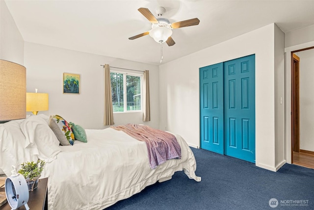 carpeted bedroom with ceiling fan, baseboards, and a closet