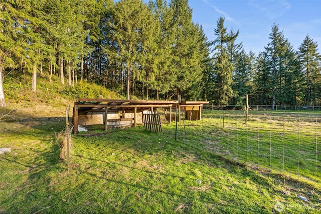 view of yard with fence and an outbuilding