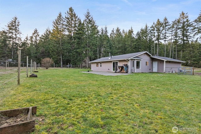 back of property featuring a patio, a lawn, and fence