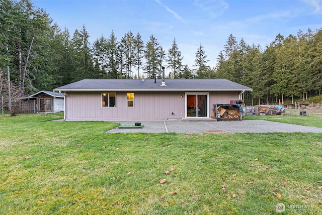 back of property featuring a patio and a lawn