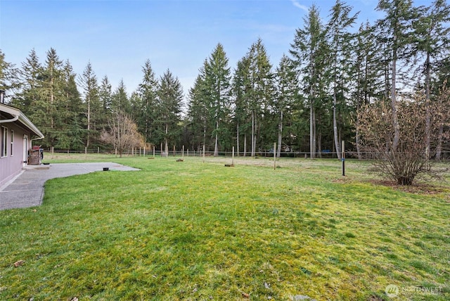 view of yard with fence and a patio