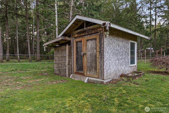 view of outbuilding with an outbuilding and fence