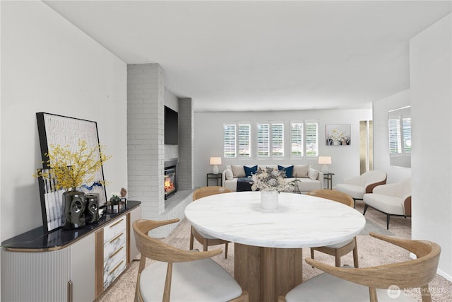 dining space with a healthy amount of sunlight and a fireplace