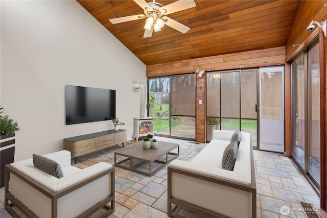 living room with wooden ceiling, plenty of natural light, vaulted ceiling, and stone tile flooring