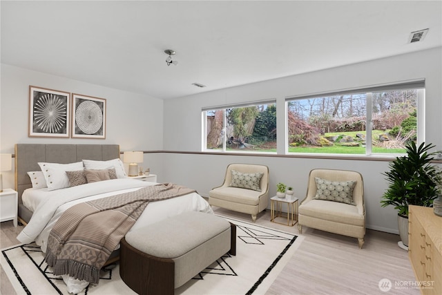 bedroom with light wood-type flooring and visible vents