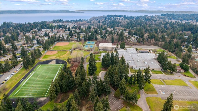 drone / aerial view with a water view and a wooded view