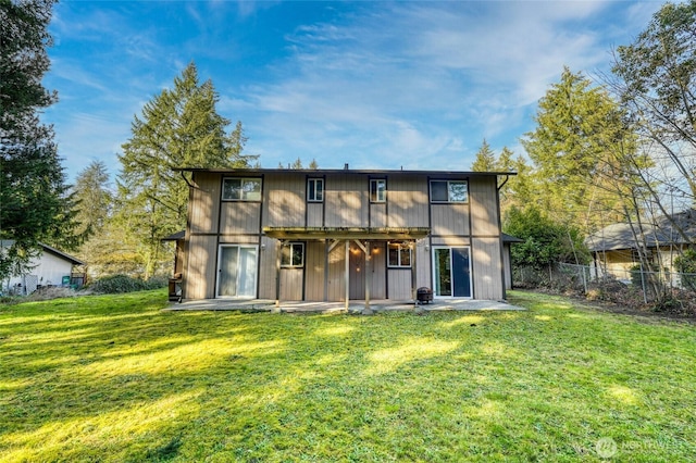 back of property with a patio area, a yard, and fence