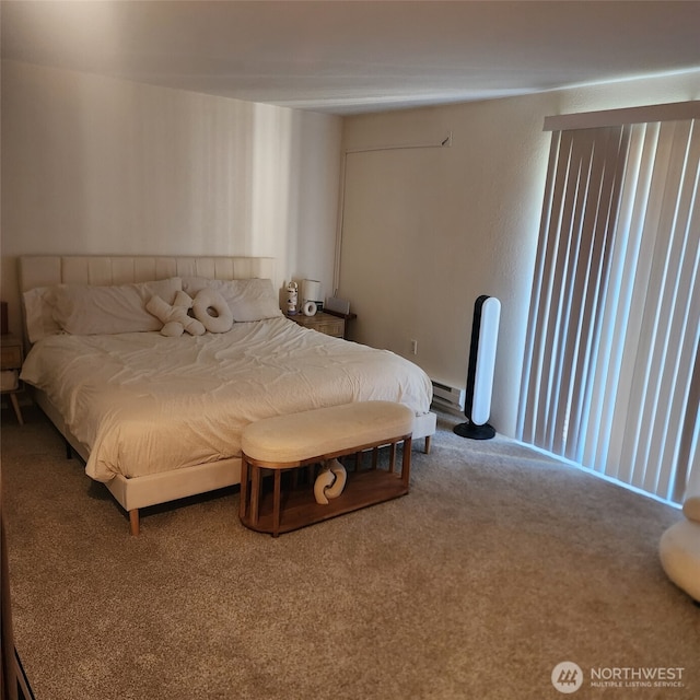 bedroom with baseboard heating and carpet flooring