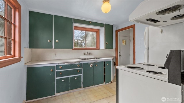 kitchen featuring ventilation hood, green cabinetry, light countertops, electric stove, and a sink