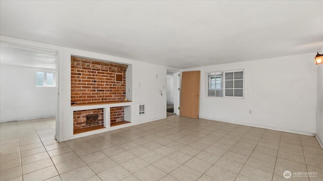 unfurnished living room featuring visible vents and tile patterned flooring