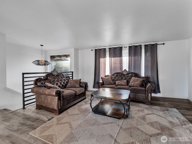 living room with baseboards and wood finished floors