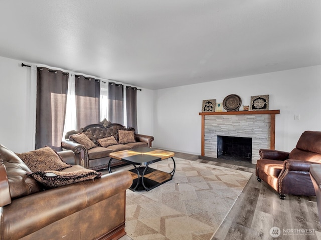 living area featuring a fireplace and wood finished floors