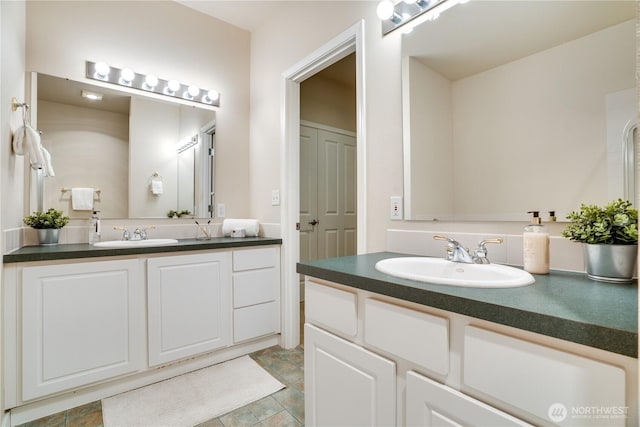 full bath with two vanities and a sink