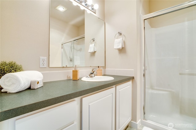 bathroom with a stall shower and vanity