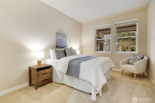 bedroom with baseboards and light carpet